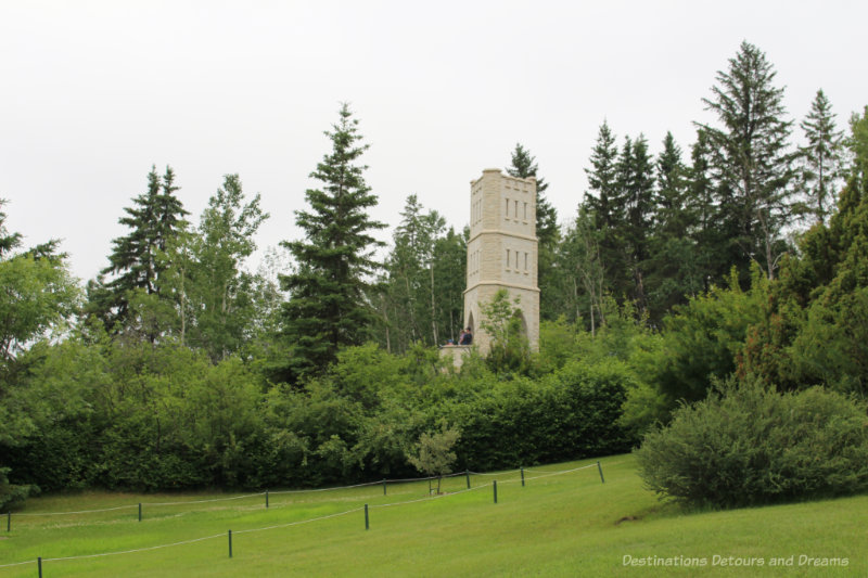 Manitoba Tyndall stone tower, John's Folly, amid trees at University of Alberta Botanic Garden