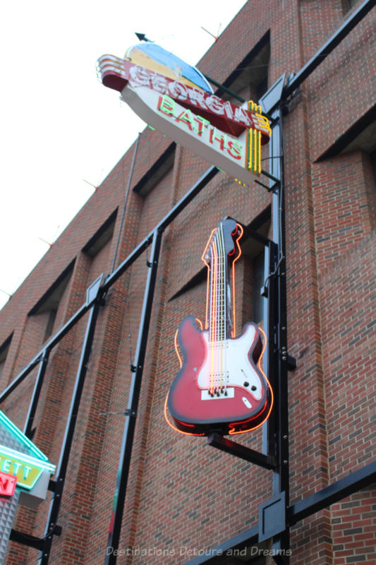 Georgia Baths and a guitar neon signs at the Edmonton Neon Museum