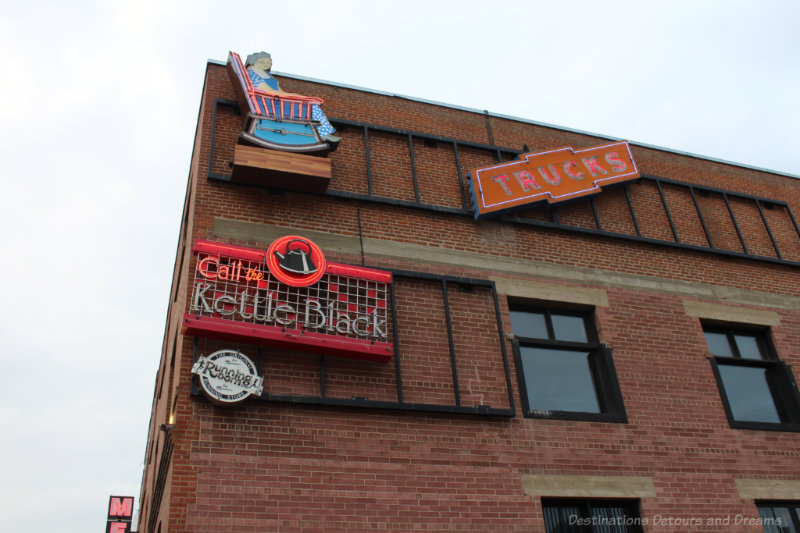 Neon signs on the red brick Mercer Building at the Edmonton Neon Museum