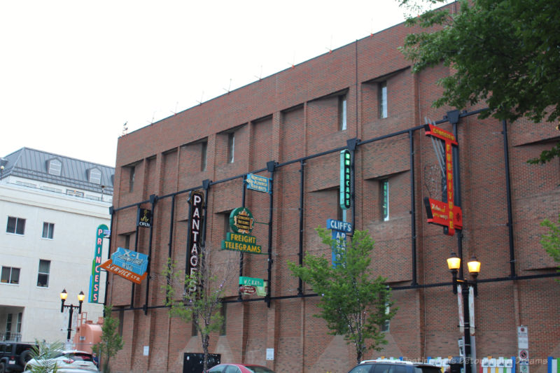 Neon signs attached to a brick wall as part of the Edmonton Neon Museum