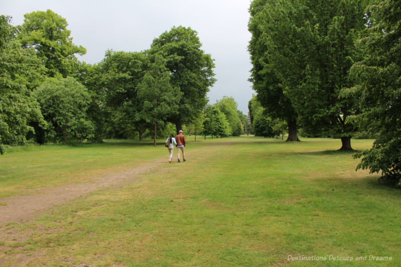 Pathway in the grass through trees at Kew Gardens