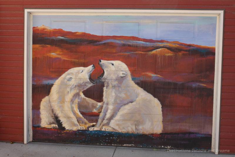 Painting of two polar bears against a red landscape on a garage in Arctic Alley, Winnipeg