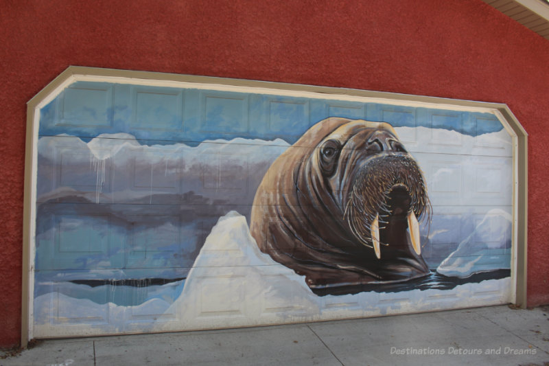 Painting of a walrus amid sea ice on a garage door in Arctic Alley, Winnipeg