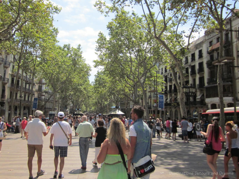 People walking down the Las Rambla broad promenade in Barcelona 