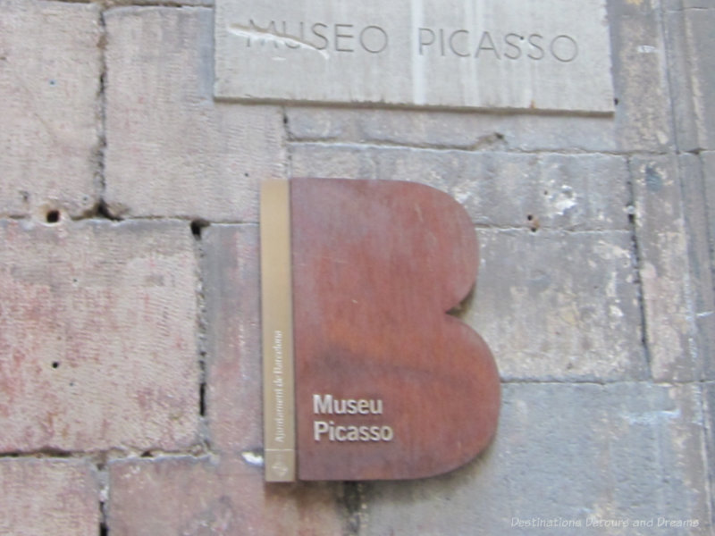 Sign for Picasso Museum on the brick wall of its exterior