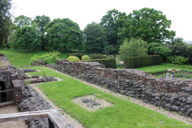 Stone ruins amid green gardens at Eltham Palace