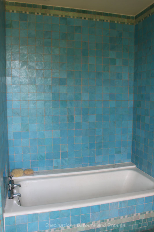 Bathtub surrounded by turquoise-coloured tiles at Eltham Palace