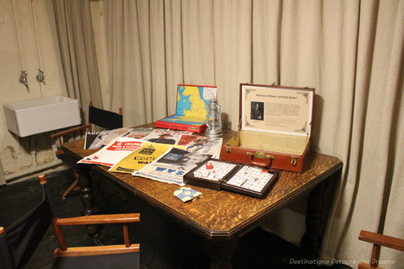 Table with display of posters, game, etc. from war time shelter at Eltham Palace