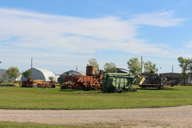 Old farm machinery in a field at the Mennonite Heritage Village