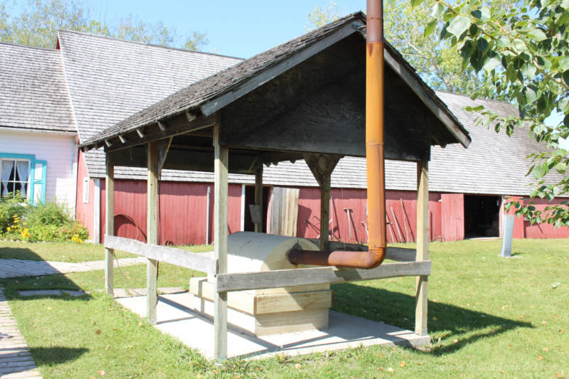 Outdoor clay oven under a wood shelter