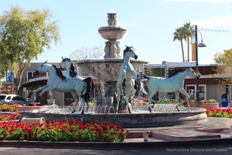 Bronze horse statue featuring 5 horses in a ring around a central fountain