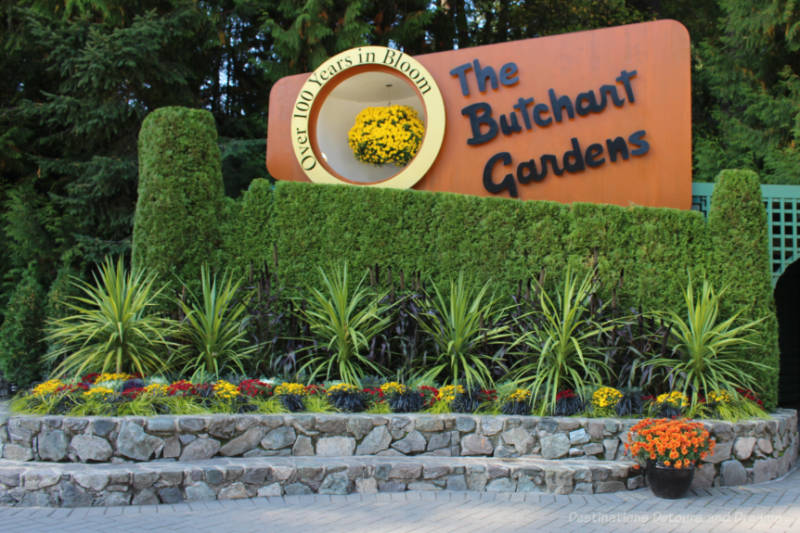 Sign and floral display at entrance to The Butchard Gardens