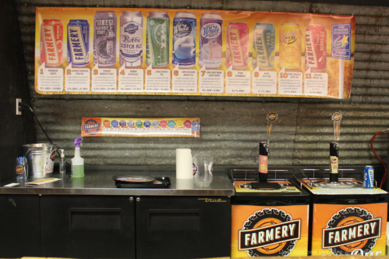 Sign with photos of beer available for tasting at Farmery Brewery