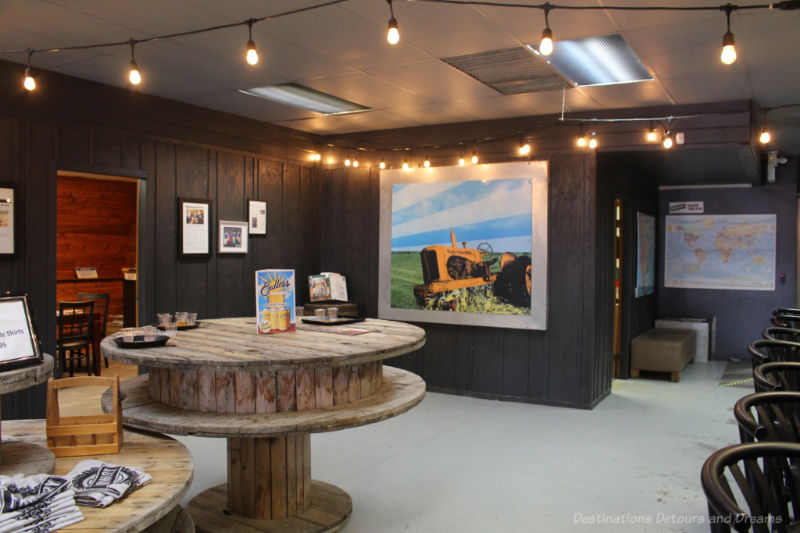 Rustic table and picture of tractor on wall at Farmery tasting room