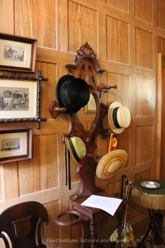 Hat rack in entry wall with wood-grained wallpaper