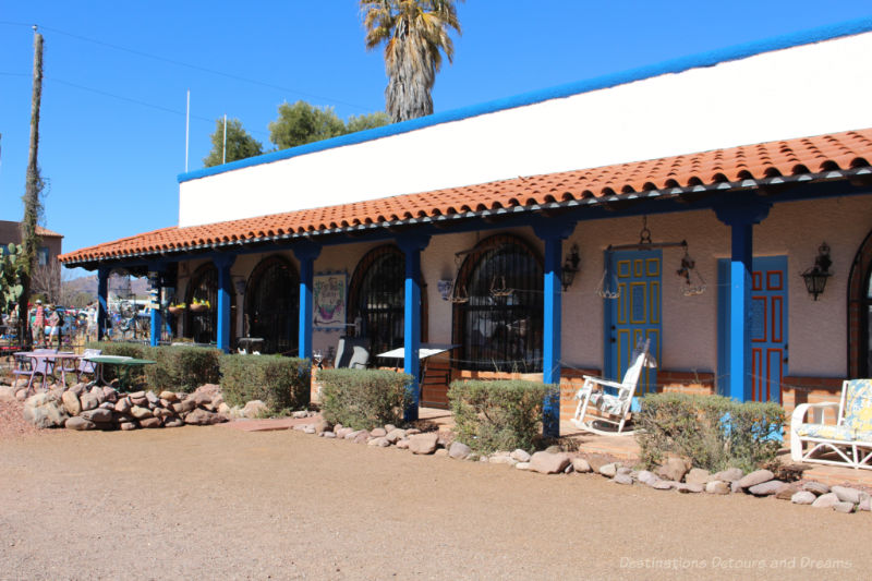 Adobe building with red-brick covered veranda area