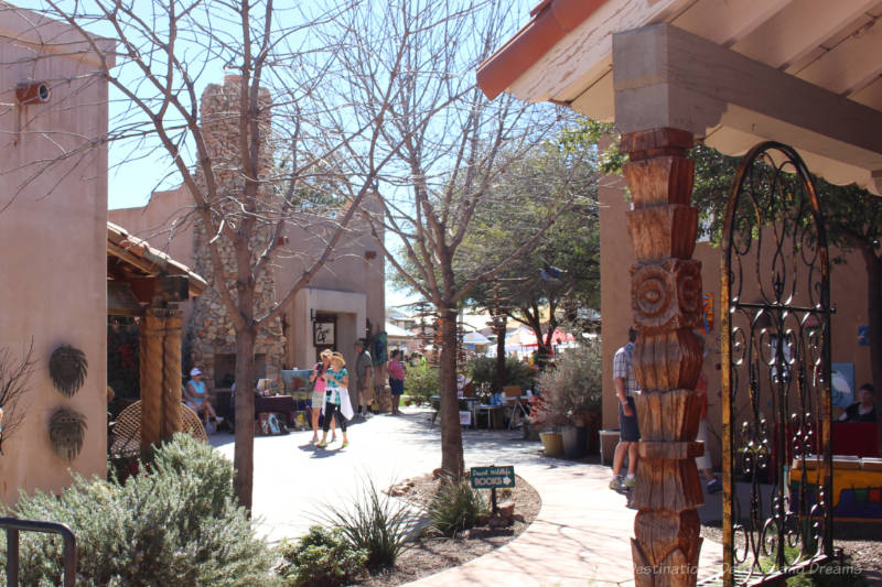 Adobe shops connected by landscaped walkway in Tubac