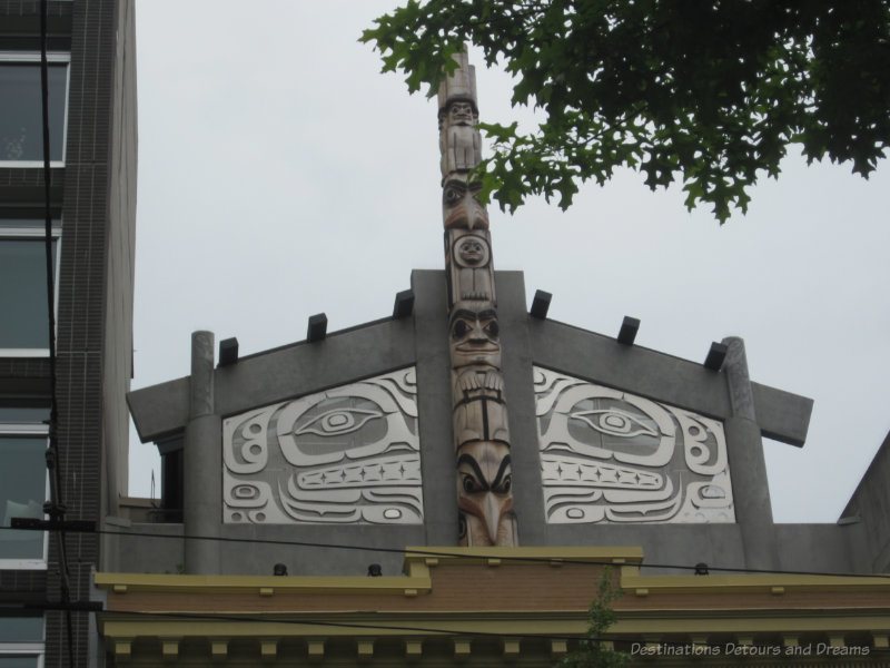 Totem pole art atop a building in Vancouver