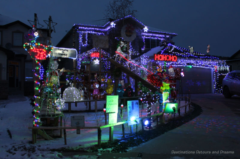 House and yard of decoration lit up with Christmas lights