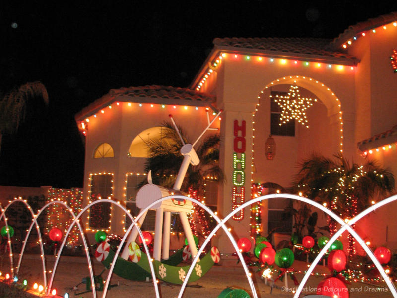 Ho Ho Ho Christmas Display House lit up for Christmas with HoHoHo and a star
