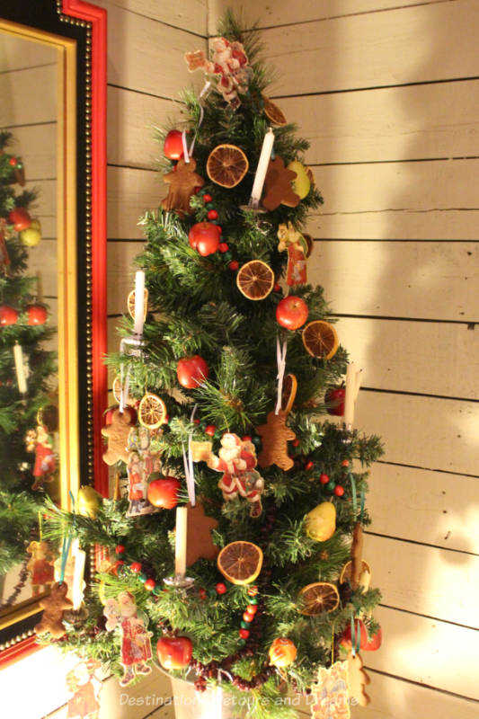 Victorian era Christmas tree with candles and dried fruit decorations