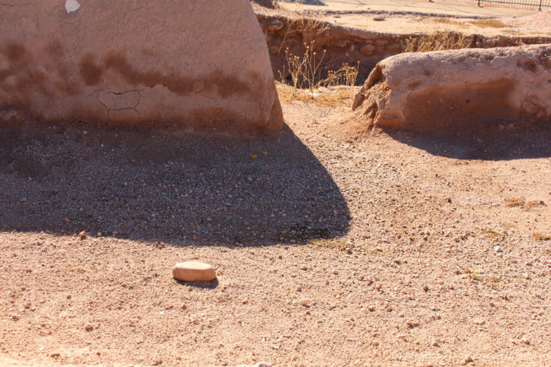 Sandy wall ruins and a shadow along the soil - remains of a Hohokam solstice room