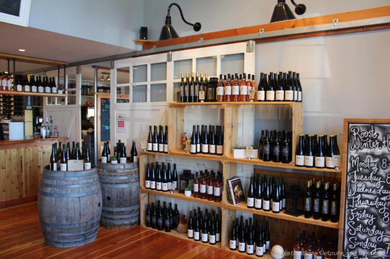 Wine for sale on wooden crate shelves at The Roost