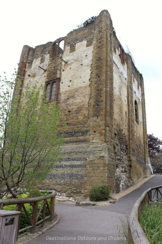 Looking up the hill to the stone walls of medieval Guildford Castle Tower from the back