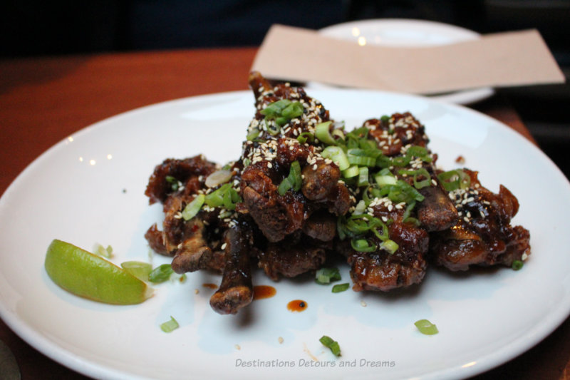 Duck wings topped with scallions at Mobys Pub