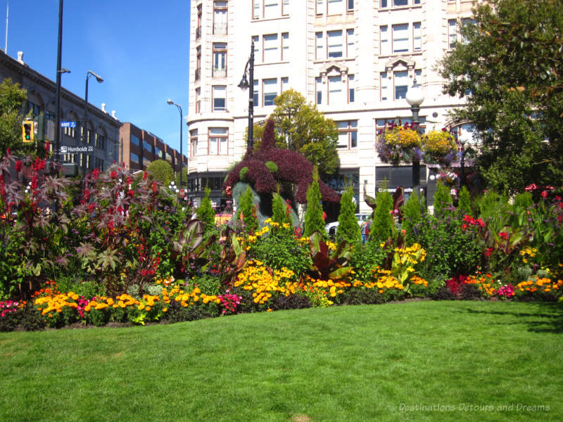 Tall flowering bushes and shorter annuals at the edge of grass lawn