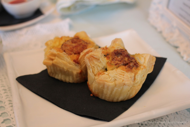 Two sausage, spinach, and feta mini-quiche in puff pastry