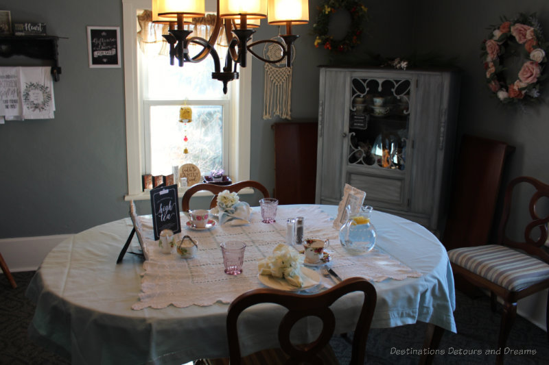 Dining room with table set with white tablecloth for afternoon tea