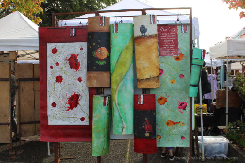 A collection of fabric art hanging at Salt Spring Island Saturday Market