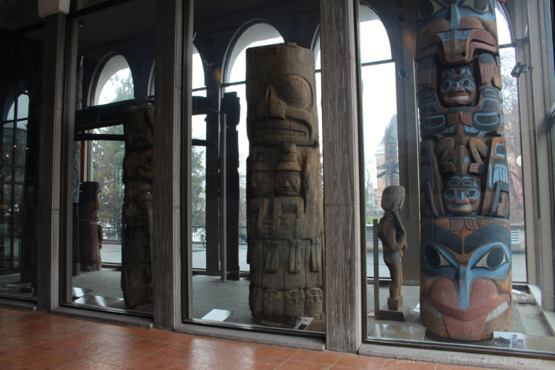 Totem poles inside the entrance of the Royal BC Museum in Victoria, British Columbia