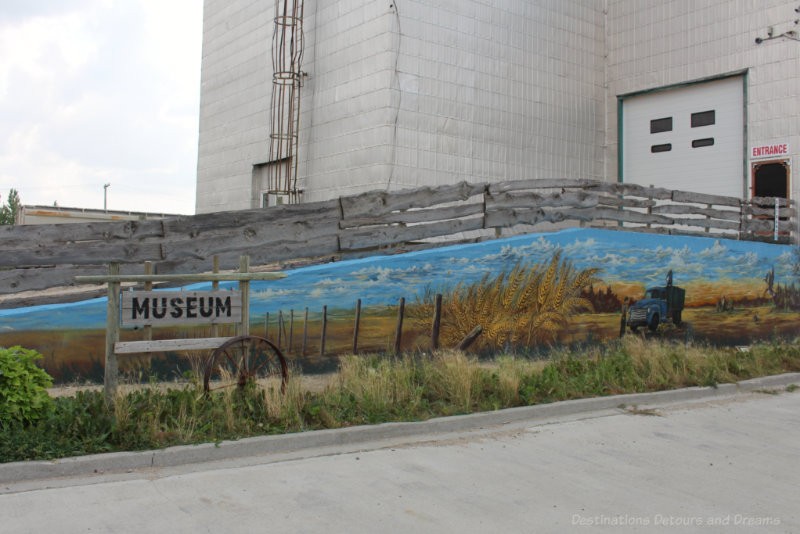 Prairie grain field mural on the ramp leading to a small town Manitoba museum housed in a former grain elevator