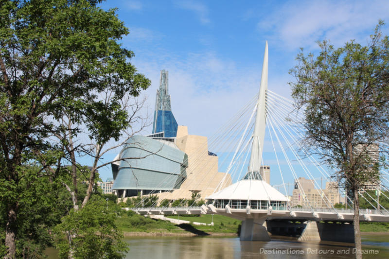 Winnipeg Landmarks: CMHR Glass and Tyndall stone Canadian Museum for Human Rights and the cabled Riel Esplanade Bridge
