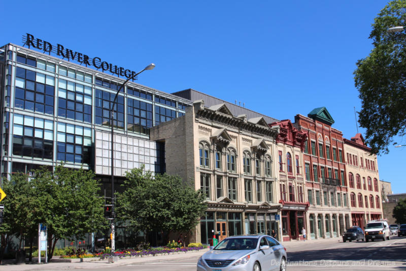 Facades if late 1800 buildings form the side of a new glass and steel building