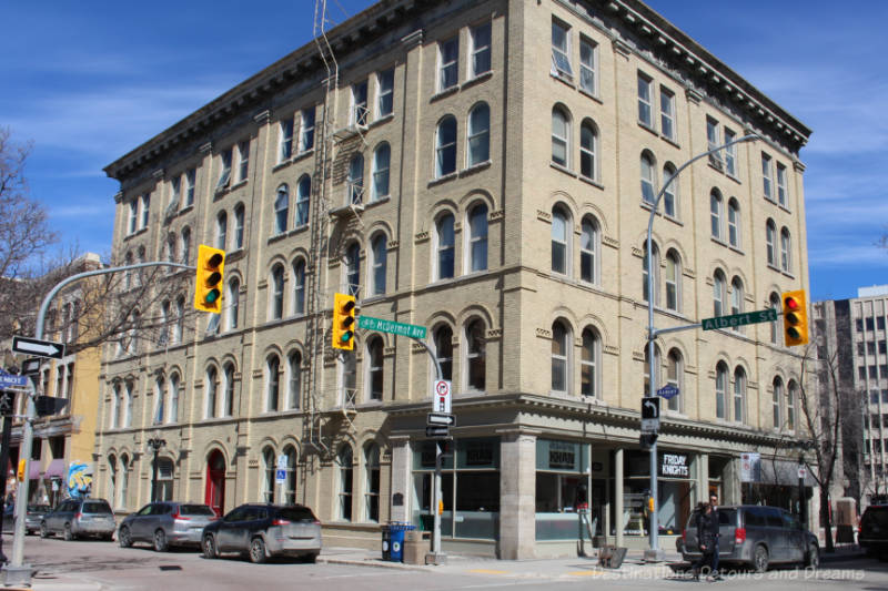 A five-story brick building on a city street corner