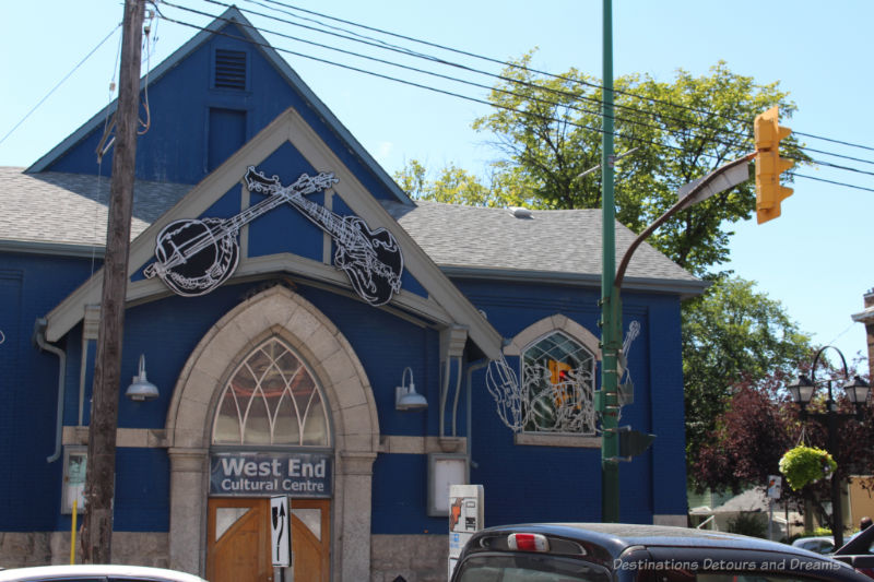 Blue building with musical cutouts decorating windows and the area above the door