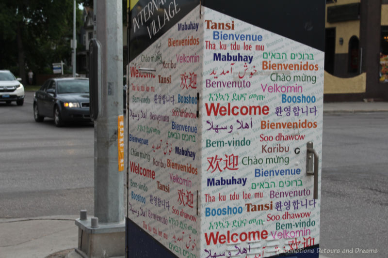 An electric box covered with words saying Welcome in different languages