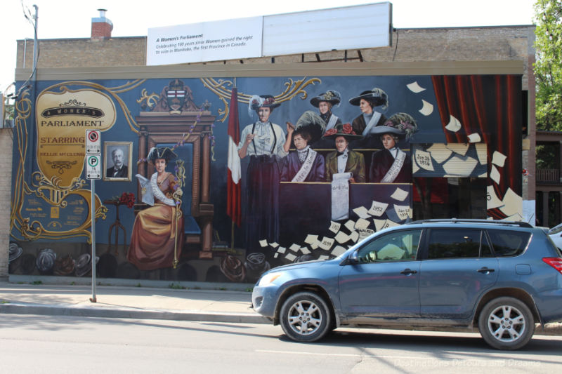 A mural on the outside wall of a building depicting a woman's mock Parliament for the right to vote