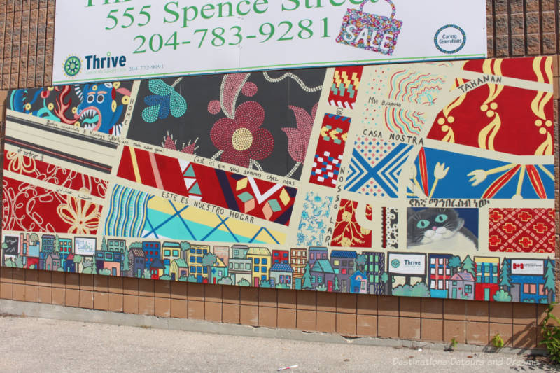 Mural shows street map as a quilt with colourful textiles from various countries forming the blocks