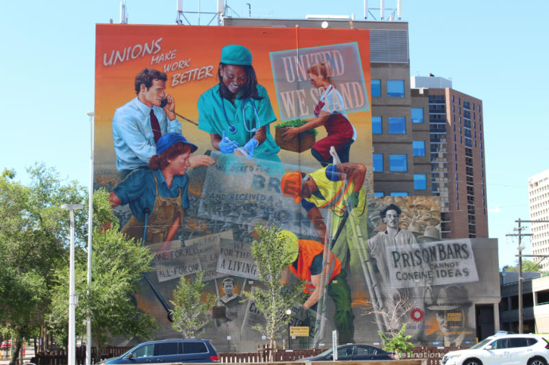 A several story high mural with a collage of scenes representing the history of the Manitoba labour movement from the Winnipeg 1919 General Strike to present day. 