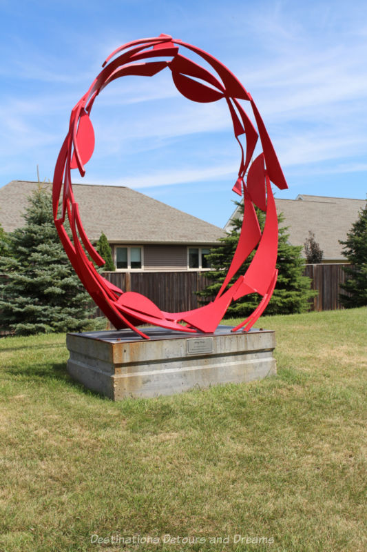 Outdoor sculpture of a large stylized red ring