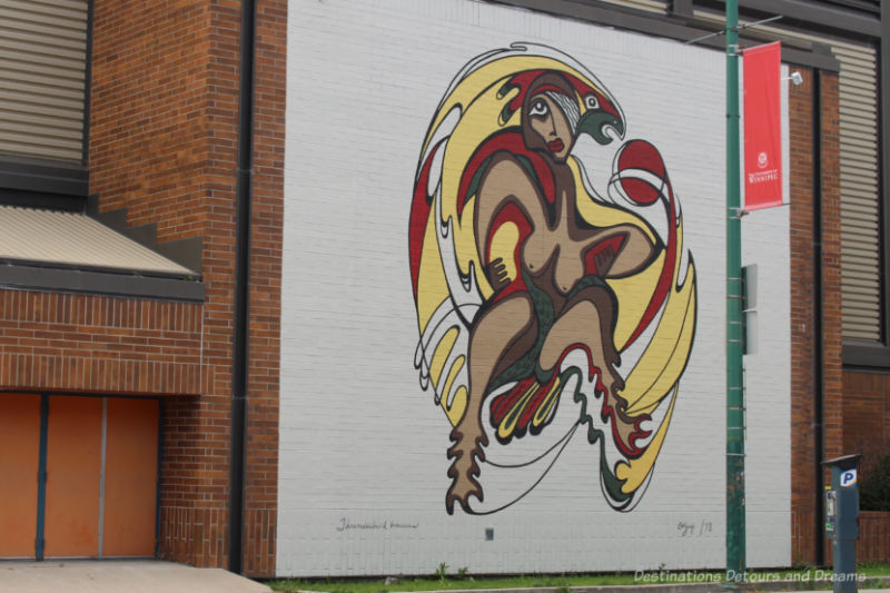 Tribute mural of The Thunderbird Woman by Daphne Odjig represents a figure of transformation, half-woman/half bird