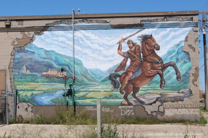 Mural featuring Sir William Wallace with sword on horse in Scottish landscape