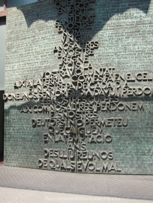 Eucharist Door of La Sagrada Família with raised lettering in a variety of languages