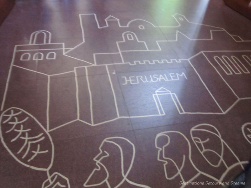 Markings on the floor of La Sagrada Família at the Passion Facade entrance symbolize the entrance to Jerusalem