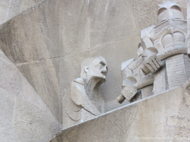 Stone sculpture of Gaudi on La Sagrada Família Passion Facade