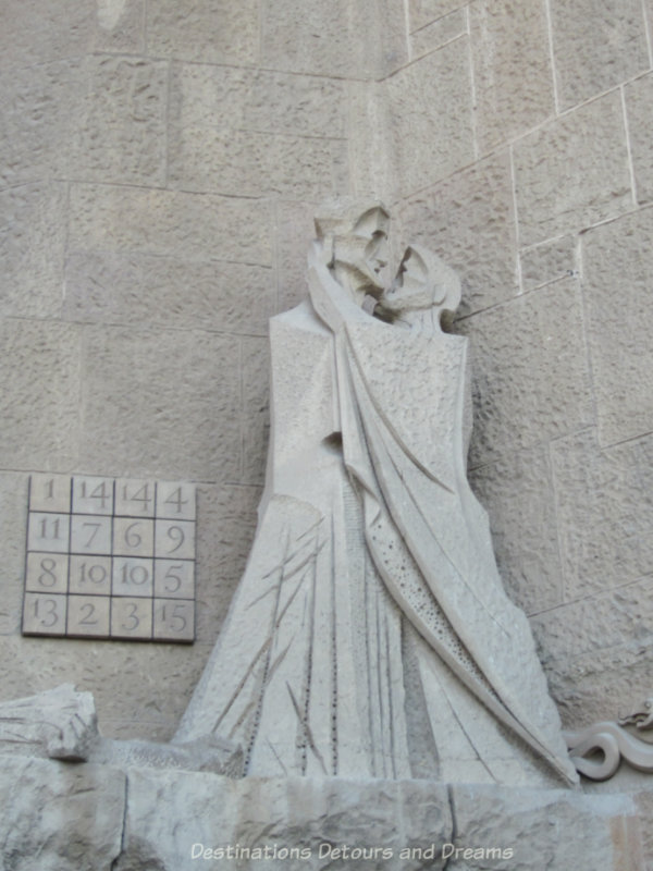 Sculpture on La Sagrada Família Passion Facade showing Peter's betrayal of Jesus and a number puzzle